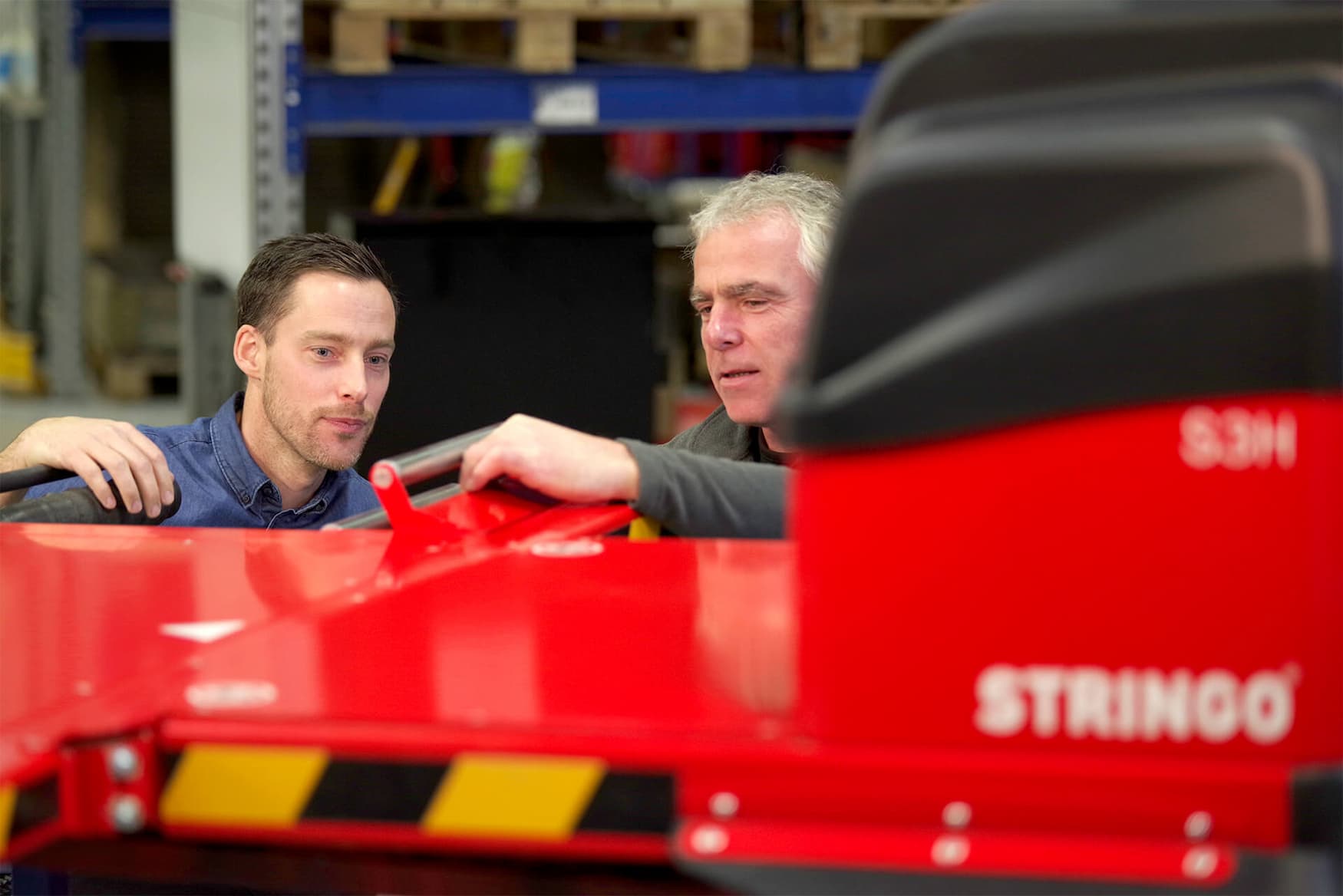 Two engineers using a high-performance vehicle mover from Stringo